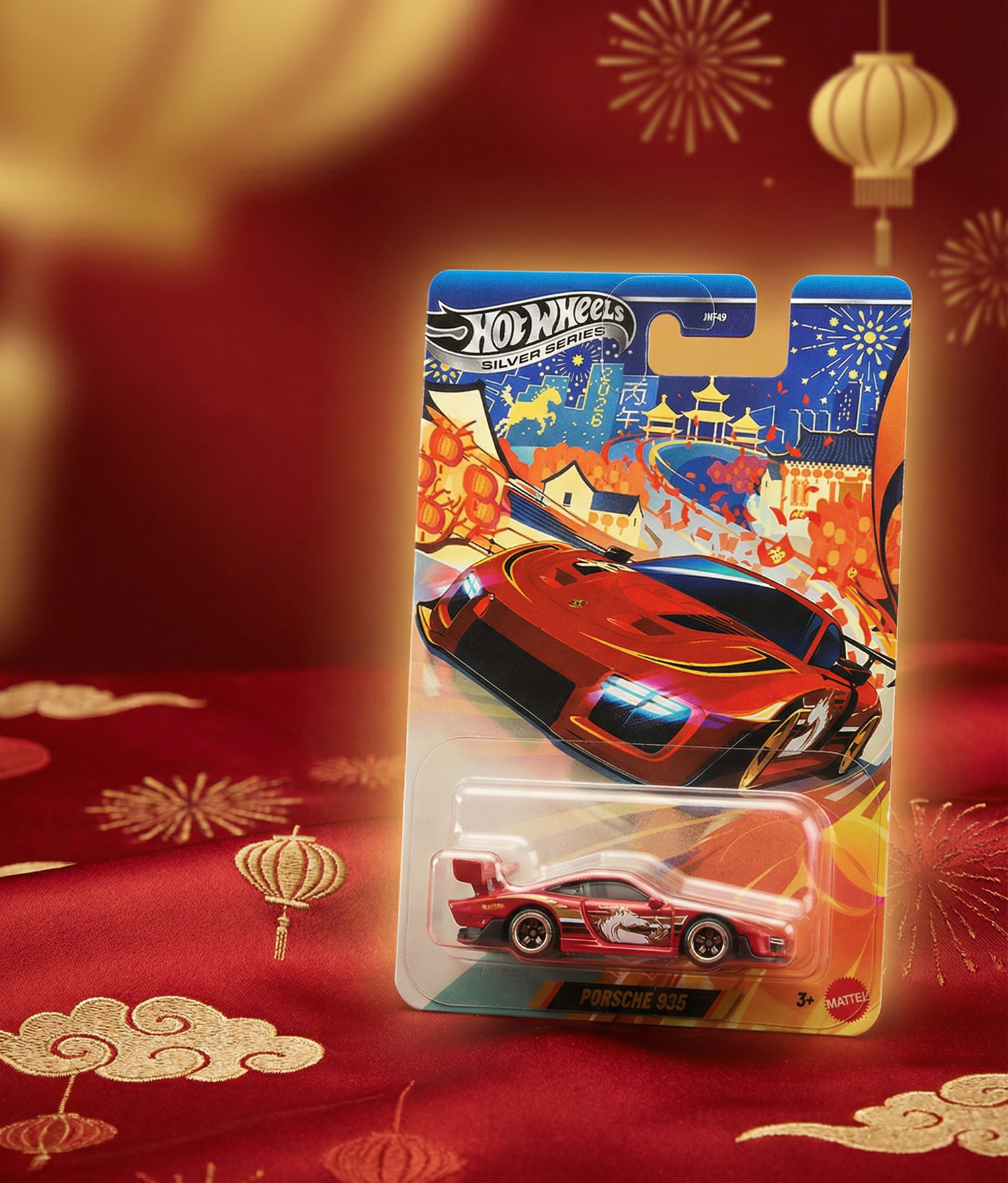 Hot Wheels LUNAR NEW YEAR toy car in packaging on a red background with festive decorations