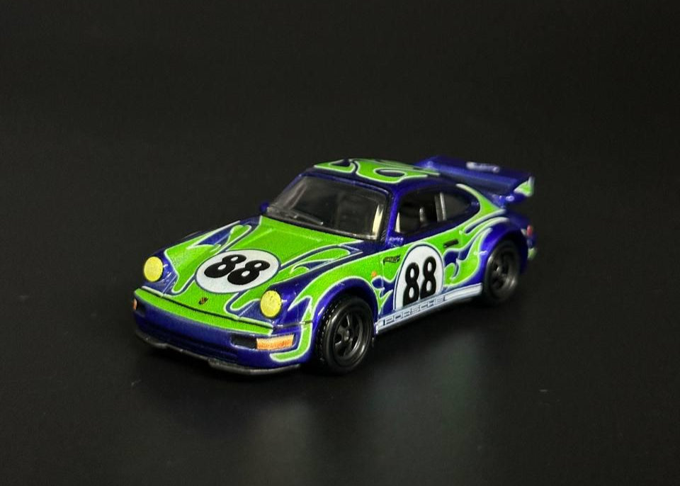 Model car with green and blue design on a black background